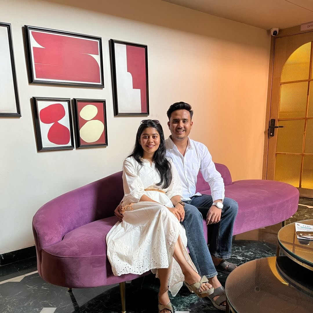 Sarthak Interior Studio founders seated together in a studio lobby